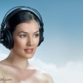 7284198-girl-with-headphones-on-the-sky-background